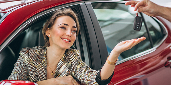 Premium car rental vehicle parked in a modern indoor parking space